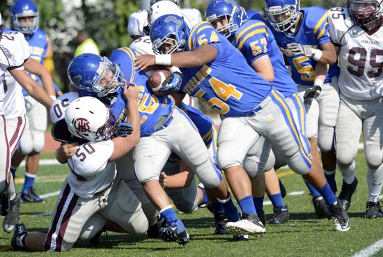 Joliet Central's Miguel Rodriguez (35) is brought down by Lockport's Jesse Kwak (50)on Saturday, September 15, 2012. | Larry Kane~For Sun-Times Media