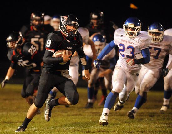 Huntley quarterback Kameron Sallee (9) is chased by Dundee-Crown's Cordero Parson (23) and other Chargers during Friday night's game at Huntley. Huntley beat Dundee-Crown 31-28. September 21, 2012 | Michael Smart~Sun-Times Media 