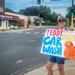 Minneapolis Roosevelt parent holding up a car wash sign on the street corner