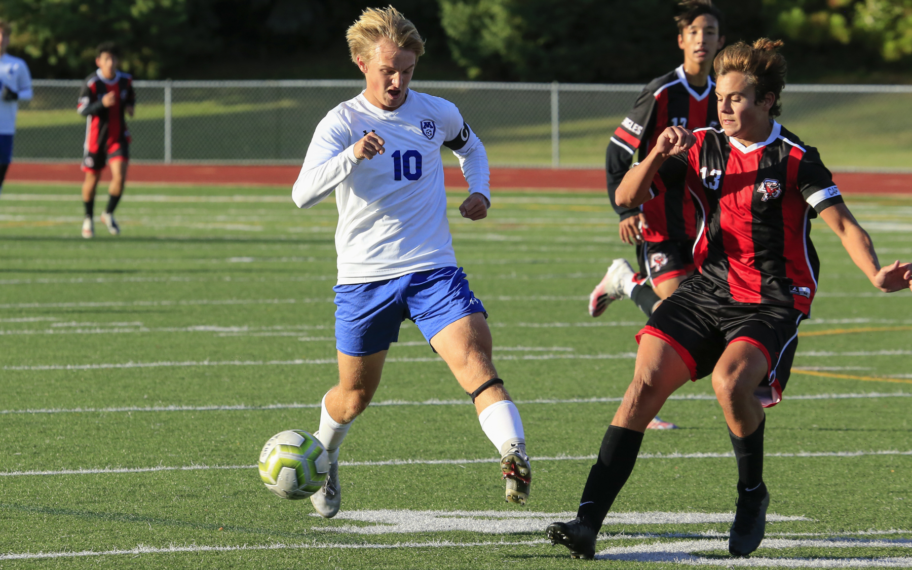 Minnetonka's Dylan Olson (10) gains position in front of Eden Prairie's Cole Nelson (13) during Thursday evening’s match. Olson’s goal late in the second half gave the Skippers a 1-0 victory over the Eagles. Photo by Jeff Lawler, SportsEngine