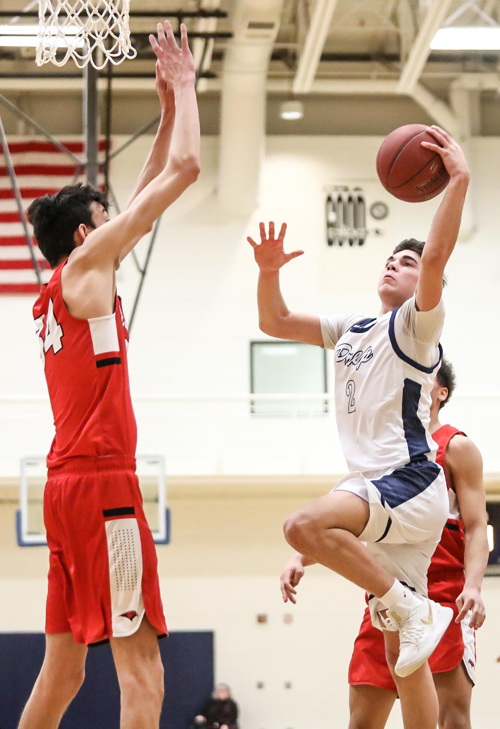 Addison Metcalf (2) faces off against Chet Holmgren at the basket. Metcalf scored 10 points for St. Croix Prep in a 68-48 loss to Minnehaha Academy. Photo by Cheryl Myers, SportsEngine