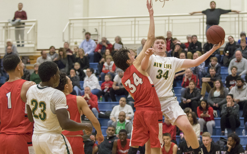 New Life Academy's Drew Wynia looks for space to shoot under the basket against Minnehaha Academy. The Eagles fell to the Redhawks 77-34 in the Class 2A, Section 4 final in St. Paul. Photo by Jeff Lawler, SportsEngine