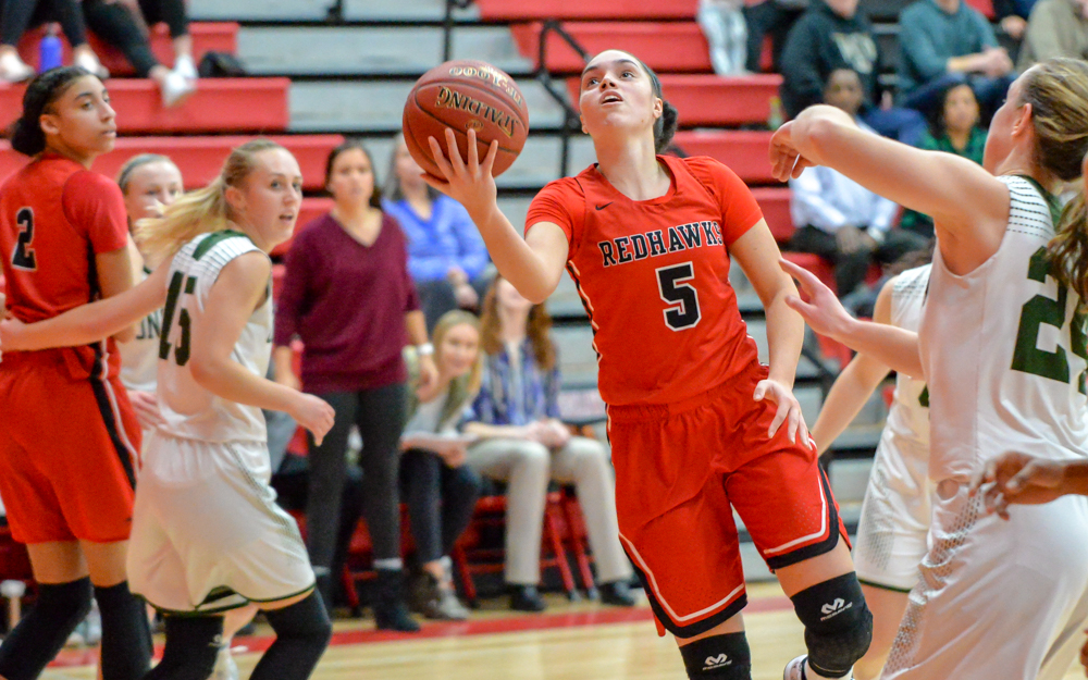 Minnehaha Academy junior Mia Curtis (5) goes for a layup Friday night at home. She had 18 points on the evening, powering the Redhawks past the Beacons 74-57.  Photo by Earl J. Ebensteiner, SportsEngine