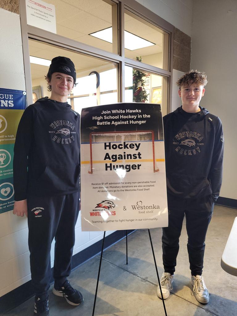 hockey players with food shelf donations