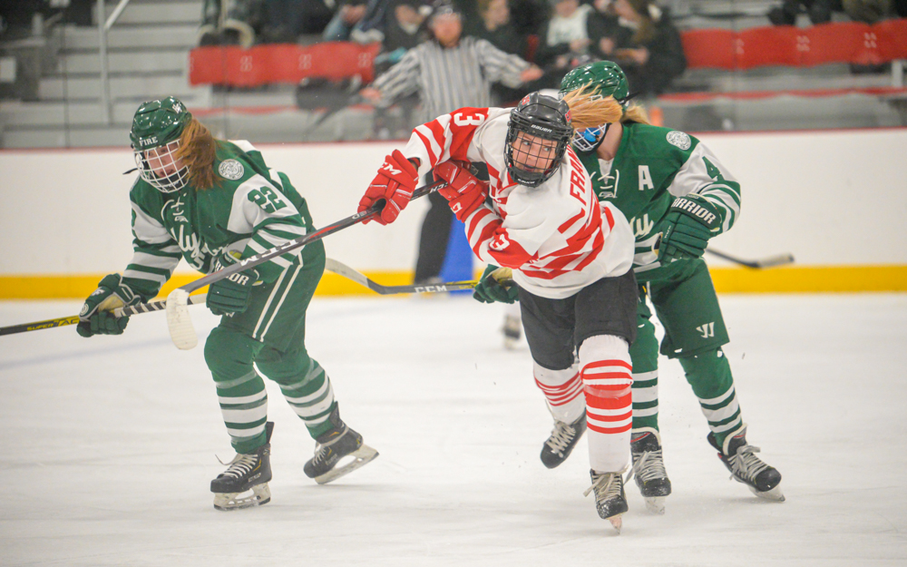 Centennial forward Summer Francis carries the puck past the blue line only to be met by the Fire’s strong defense. Centennial lost to Holy Family Catholic 3-0 at home. Photo by Earl J. Ebensteiner, SportsEngine