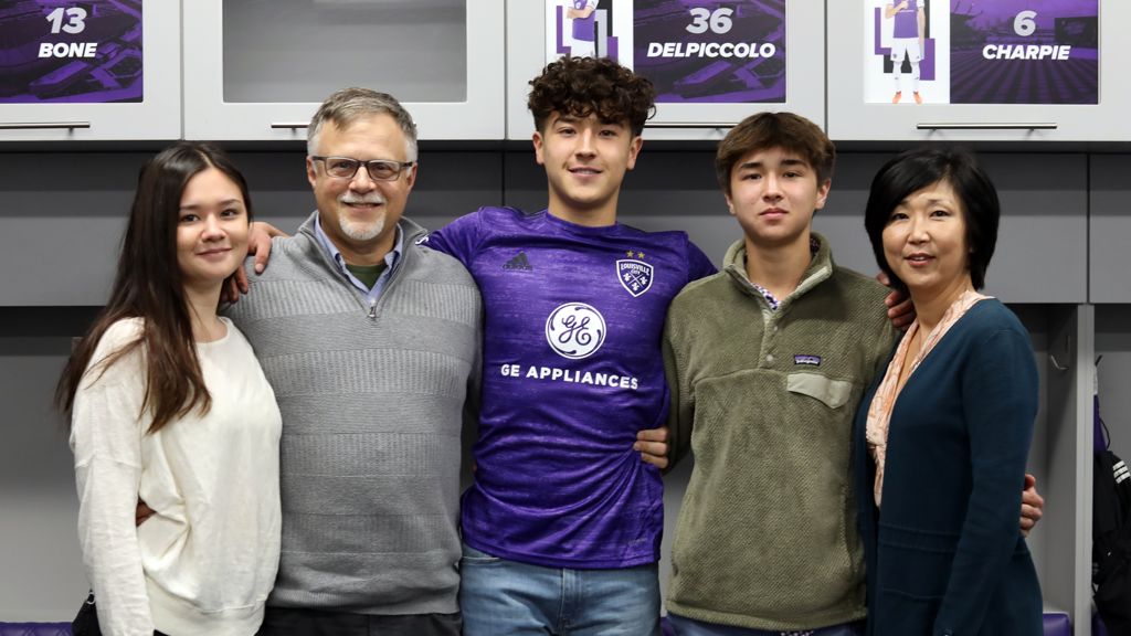 An 18-year-old Damm and his family after signing his first professional contract with LouCity in 2021.