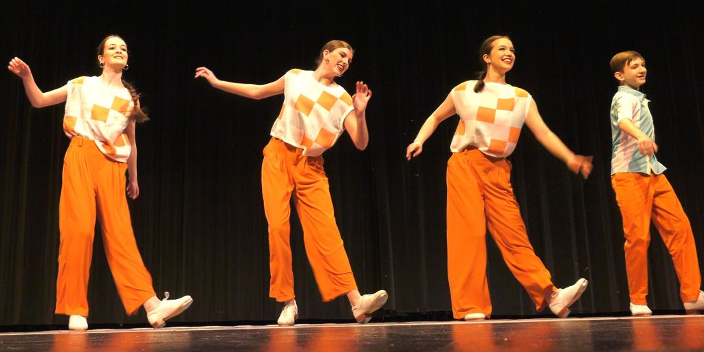 Dancers performing their tap routine on stage