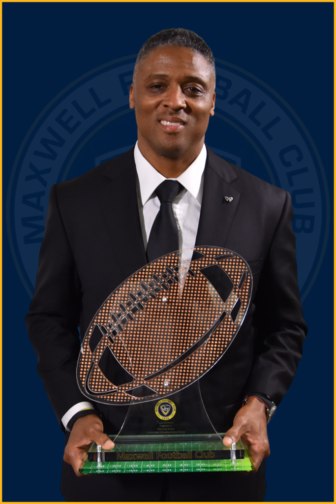 Warrick Dunn holding the MFC Legends Award