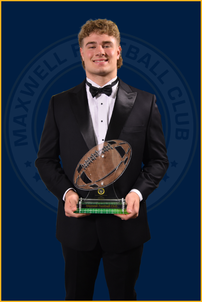 Sammy Brown holding the National High School Defensive Player of the Year Award