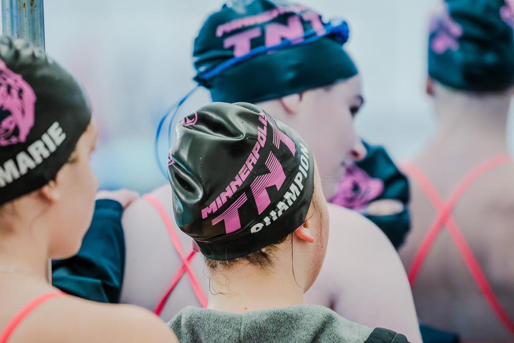 Close up of Minneapois TNT Girls Swimming swim cap featuring the TNT Tiger/Teddy logo
