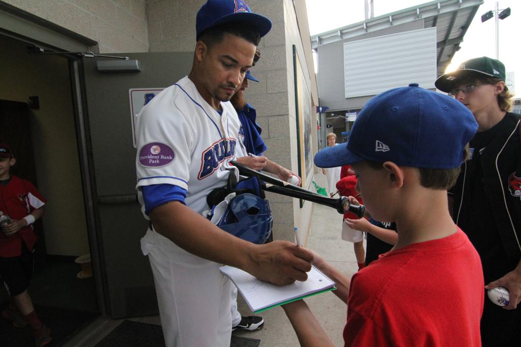Rockland Boulders player signing autographs for fans. 