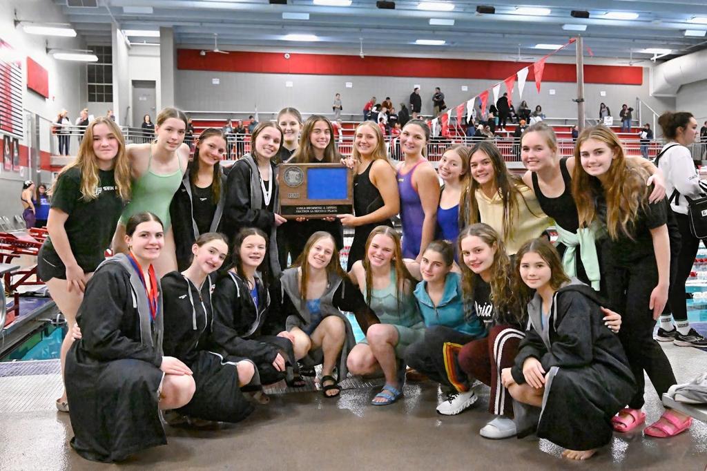 Swim team on pool deck at sections