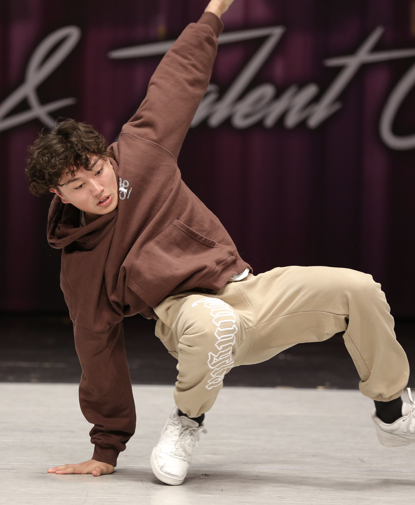 Male dancer performing his hip hop routine at a dance competition