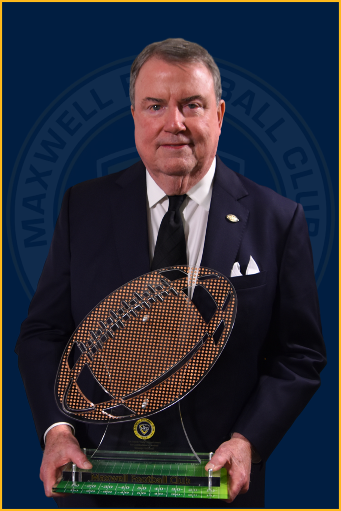 National Football Foundation CEO Steve Hatchell holding the Francis "Reds" Bagnell Award