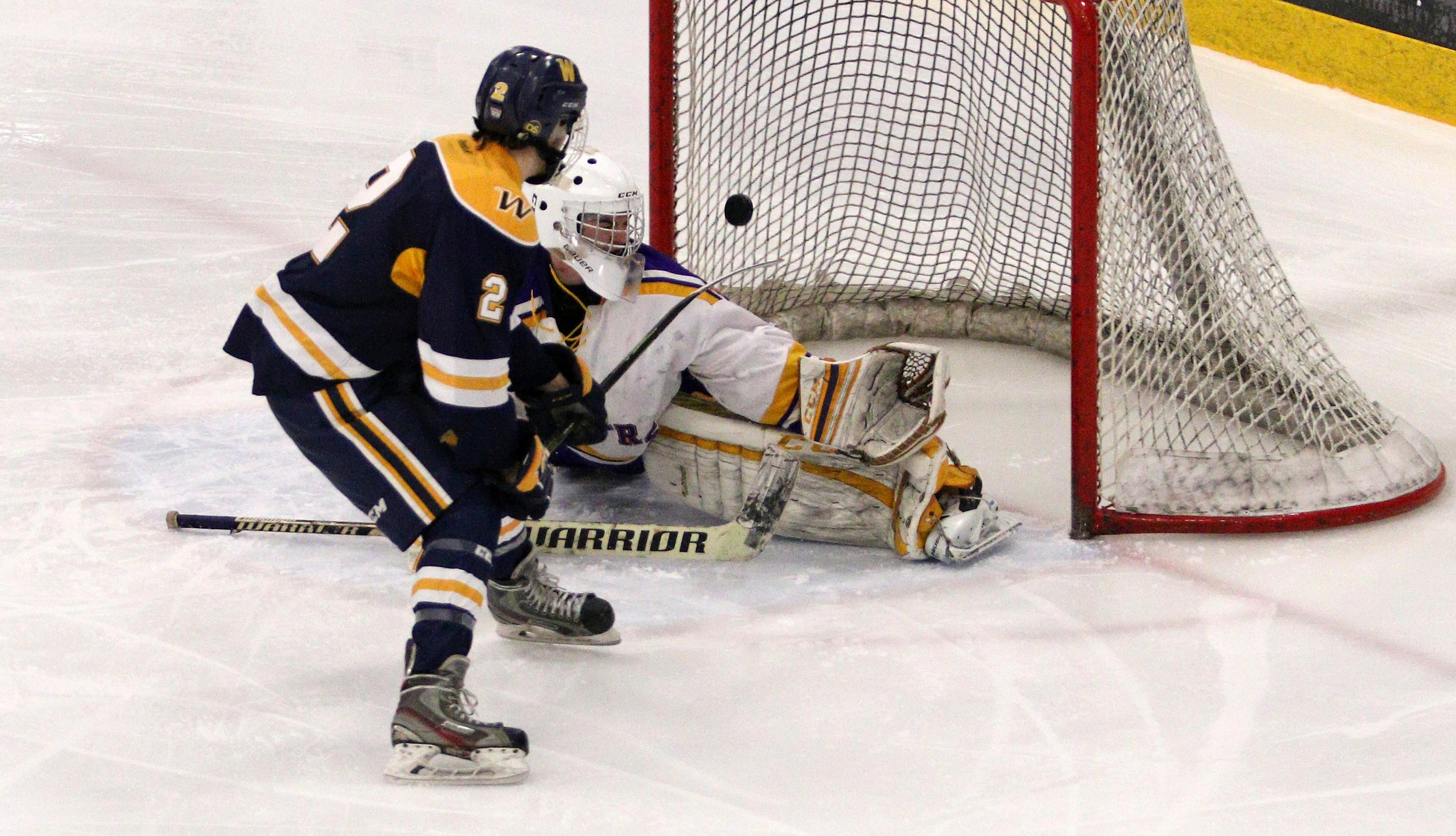 Andrew Urban scores off his backhand to give Wayzata a 2-0 lead early in the third period.  The Trojans would add a pair of empty net goals later in the period to defeat the Raiders 4-0.  Photo by Cheryl Myers, SportsEngine