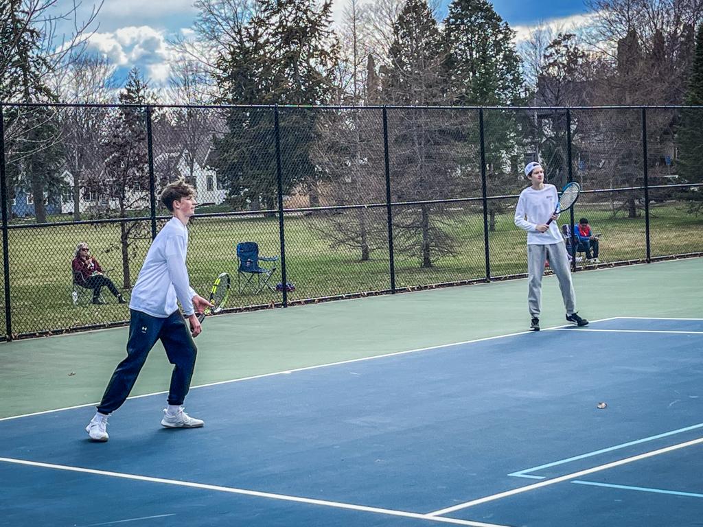 Minneapolis Roosevelt High School Teddy Boys tennis doubles players during a match at Folwell Park