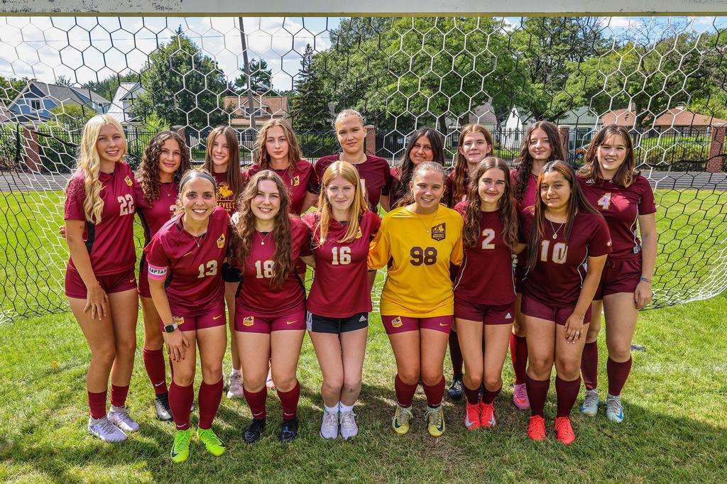 Image of Minneapolis Roosevelt High School’s girls varsity soccer team Seniors of 2025 grouped together for a photo on the field at Al Gowans Stadium