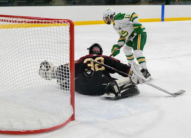 Maple Grove goaltender Lucy Morgan (32) makes a shootout save against Edina forward Annie Kuehl (11). 