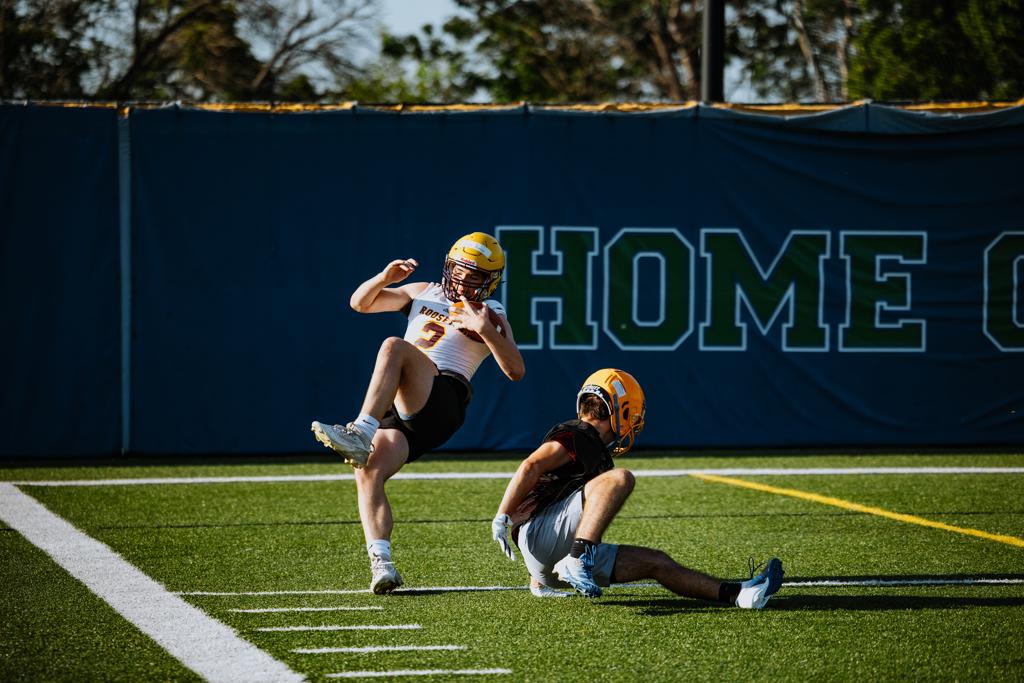 Minneapolis Roosevelt football player catches a pass during a scrimmage at Blake