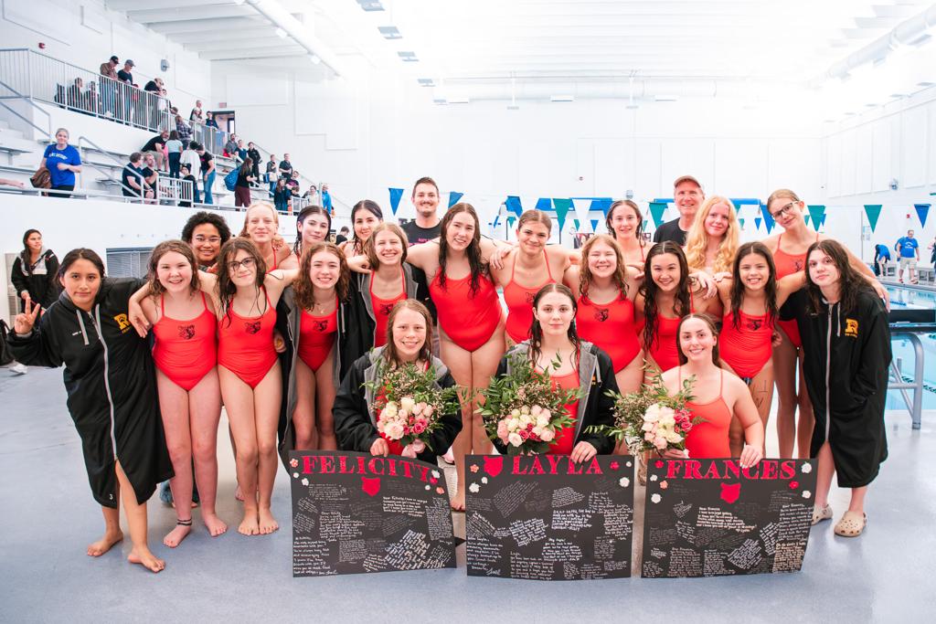 Minneapolis TNT Girls Swim & Dive team pose together at the pool during Senior Night