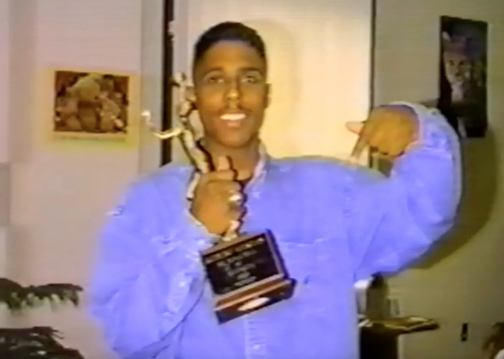 Photo of Rob Mestas holding the MN Mr Basketball Trophy