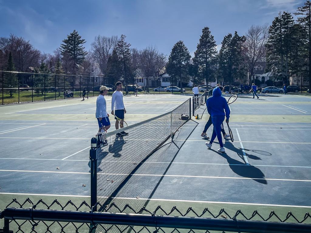 Minneapolis Roosevelt High School Teddy Boys tennis doubles teams warm up during a match at Folwell Park