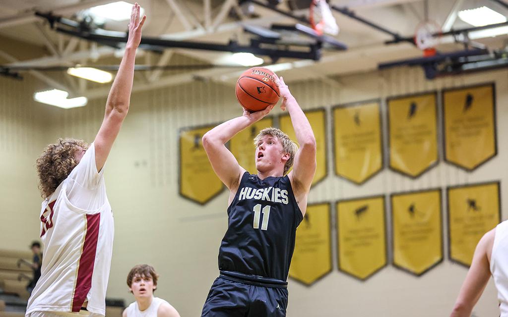 Andover's Tate Johnson takes a jump shot over a defender. Photo by Brennan Schachtner, SportsEngine 