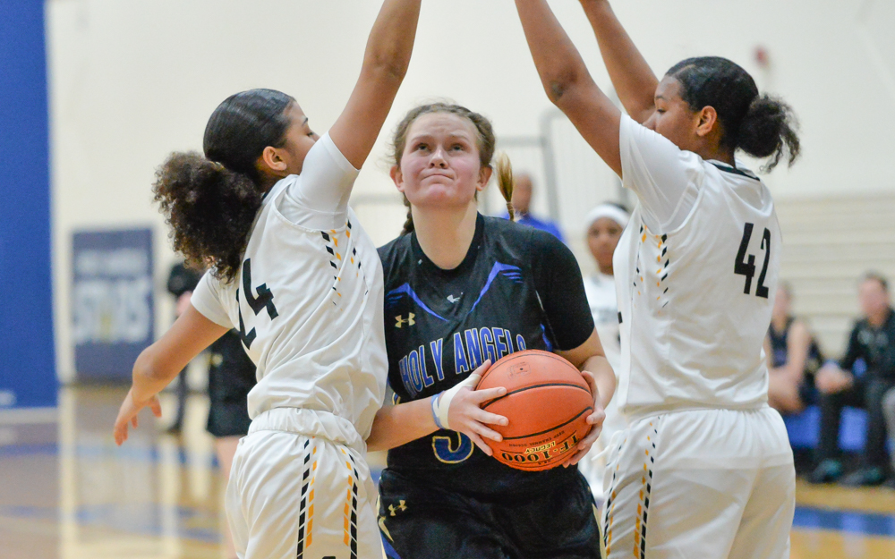 Holy Angel junior Rachel Kawiecki splits the defense and goes up for two in the first half. The Stars beat the Cougars 90-88 in front of a cheering home crowd. Photo by Earl J. Ebensteiner, SportsEngine