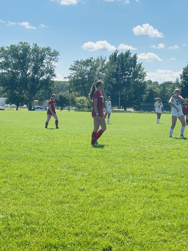 soccer player standing on field