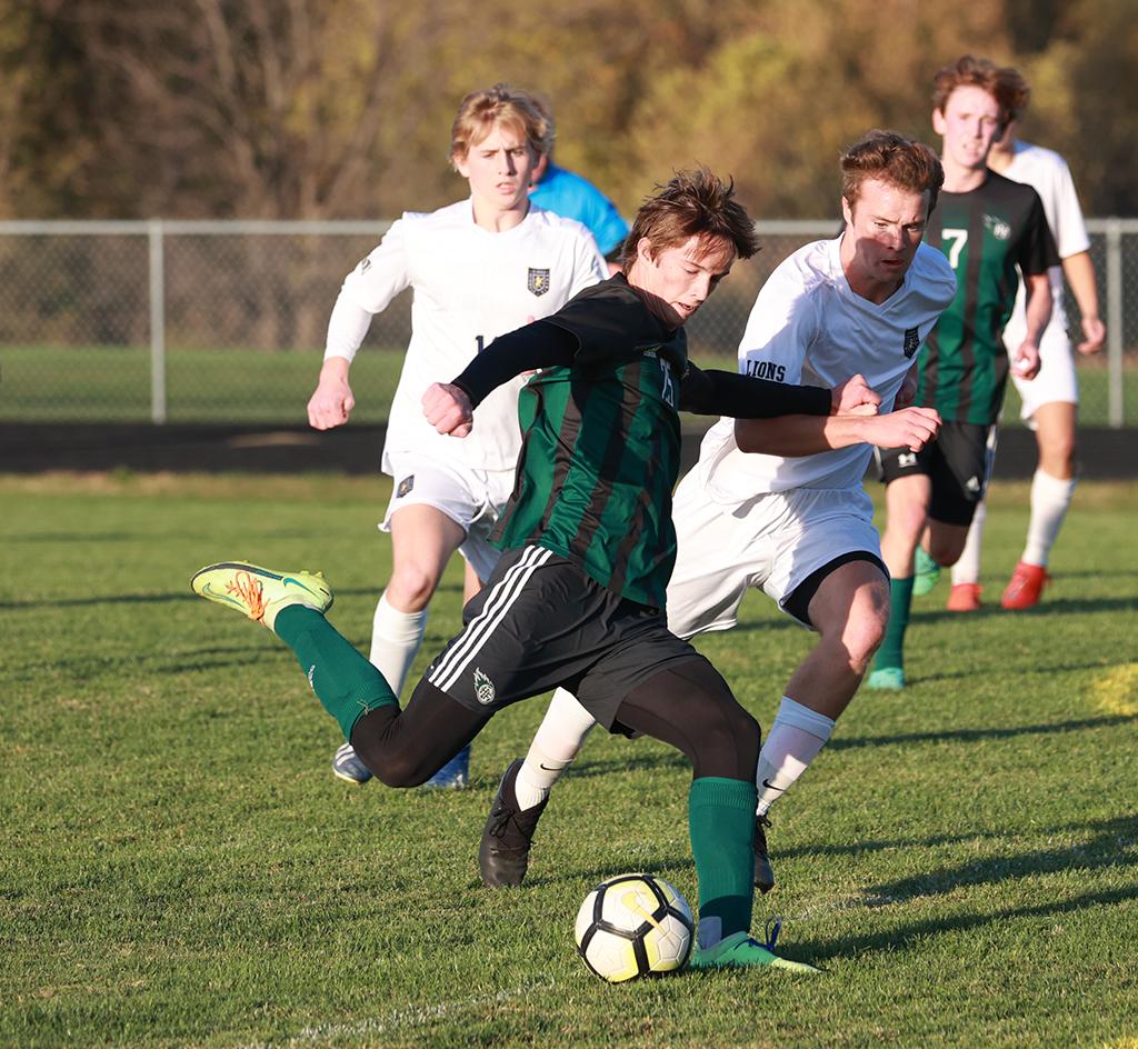 Holy Family's Thomas Laaksonen (25) sends a deep pass downfield. Laaksonen led all scoring during the season for the Fire with ten goals and one assist. Photo by Cheryl A. Myers, SportsEngine