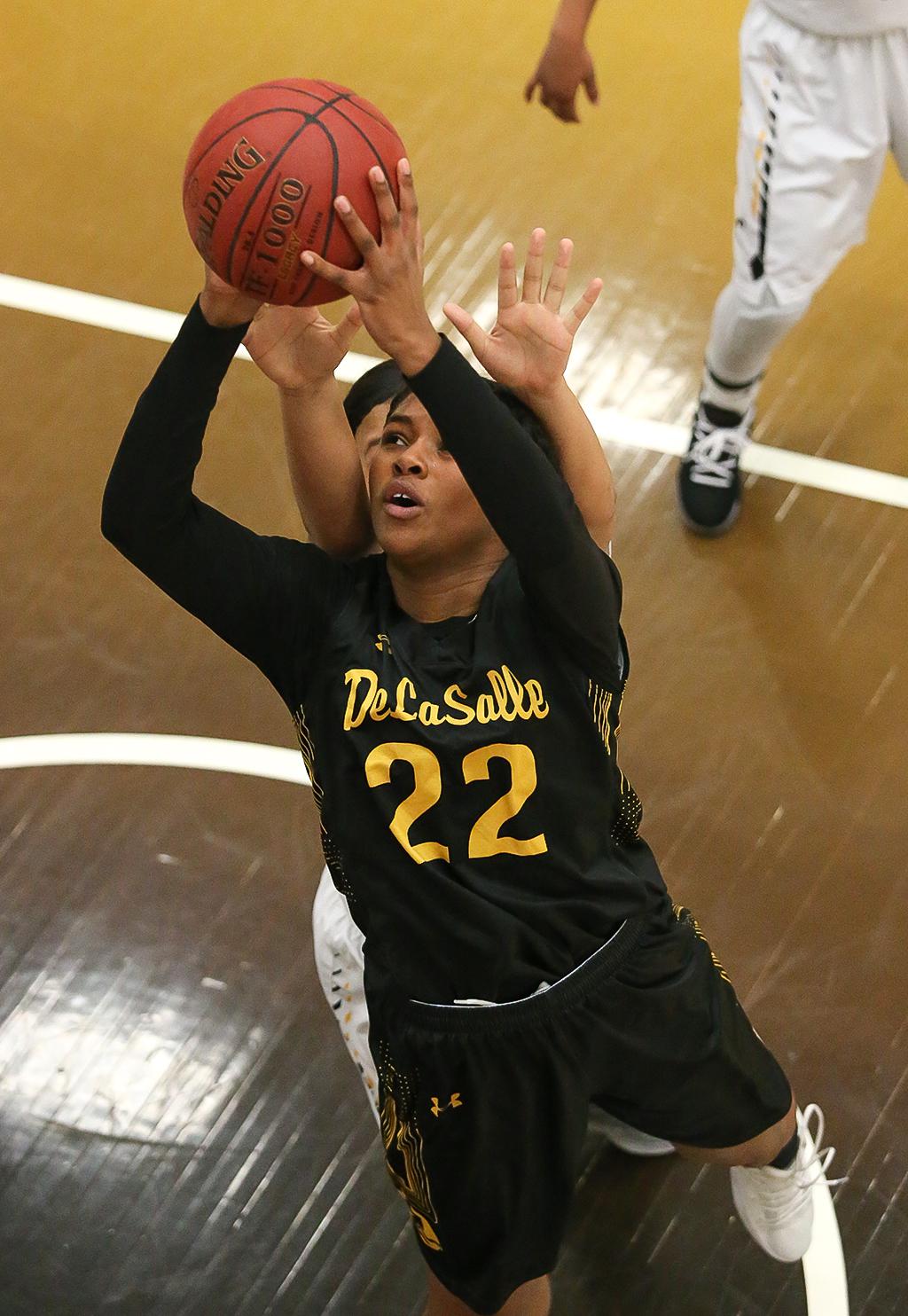 DeLaSalle junior Nurjei Weems (22) drives the lane for two of her game-high 18 points. The Islanders built an early first half lead and held on to beat the Cougars 68-54 advancing to the section final game on Thursday. Photo by Cheryl Myers, SportsEngine