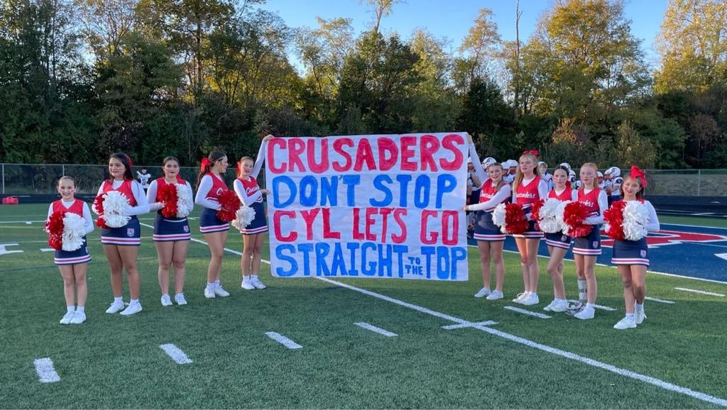 Cheerleading hold red pom poms