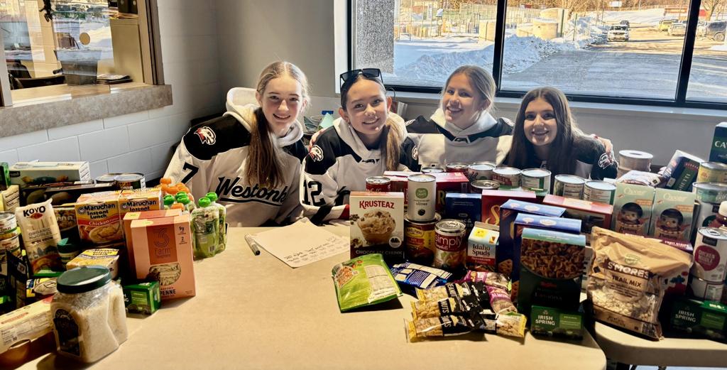 hockey players with food shelf donations