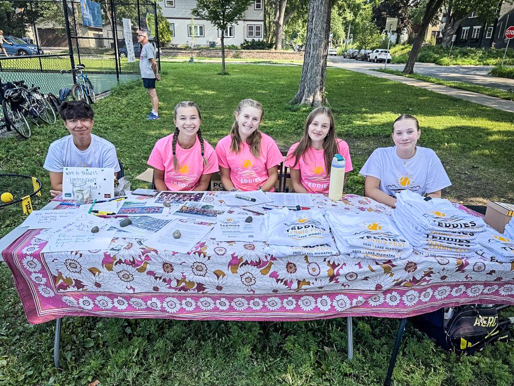 Minneapolis Roosevelt tennis players at the Check-in table at Teddies Tennis Fest 2025 at Lake Hiawatha tennis courts