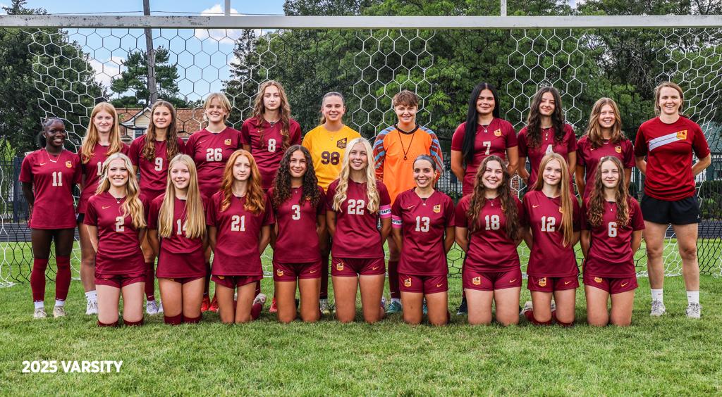 Image of Minneapolis Roosevelt High School’s girls varsity soccer team of 2025 grouped together with their coach for a team photo on the field at Al Gowans Stadium. 