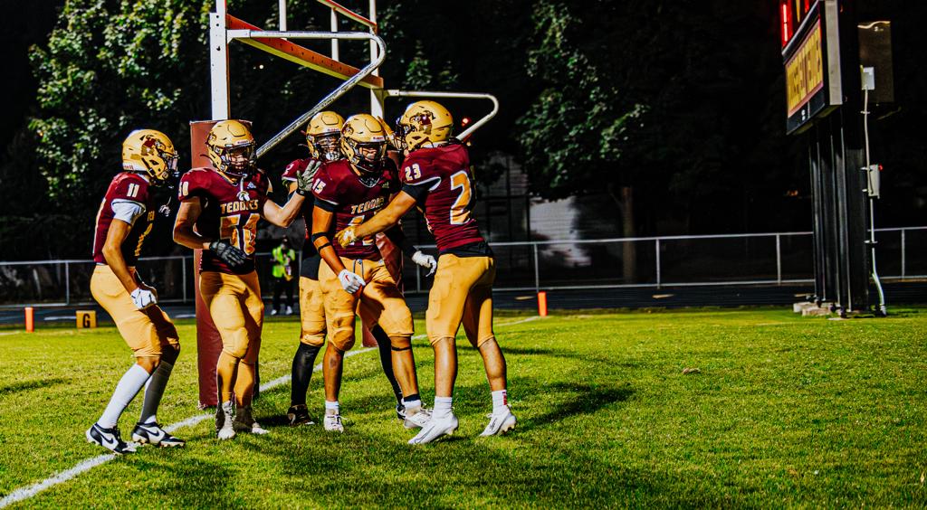 Minneapolis Roosevelt High School Teddy Football players celebrate in the endzone during a game vs South