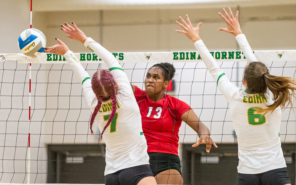 Eden Prairie’s Kendall Minta (13) records a kill in the fourth set of the Eagles' 3-1 victory at Lake Conference rival Edina on Thursday night. Photo by Earl J. Ebensteiner, SportsEngine