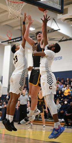 Tyler Houser shoots a basketball