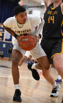 Justin Savage holds a basketball