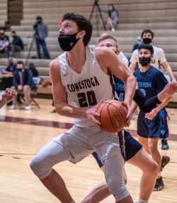 Andrew Fox dribbles a basketball