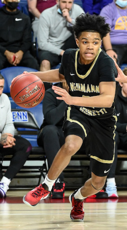 Khaafiq Myers dribbles a basketball