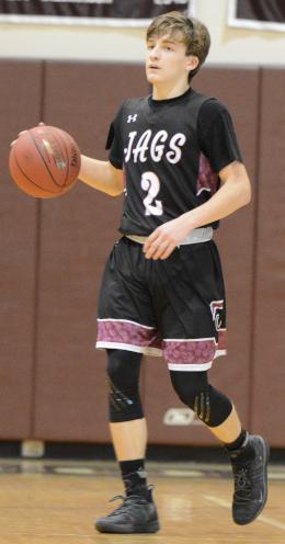 Carl Schaller dribbles a basketball