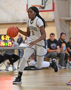 Janai Smith dribbles a basketball